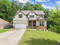 Charming two-story home featuring a two-car garage, well-manicured lawn, and inviting curb appeal at 275 Creek View Pl, Canton, GA 30114