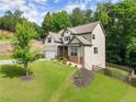 Stunning two-story home featuring an attached two car garage and beautifully landscaped yard with wooded backdrop at 275 Creek View Place, Canton, GA 30114