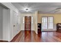 Inviting foyer with hardwood floors, decorative ceiling, and a solid wood front door at 3075 Superior Dr, Dacula, GA 30019