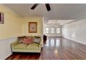 Bright living room featuring hardwood floors, stylish lighting, and neutral paint colors at 3075 Superior Dr, Dacula, GA 30019