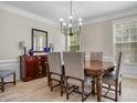 Elegant dining room featuring a modern chandelier and a dark wood table with upholstered chairs at 3962 Coventry Park Ln, Peachtree Corners, GA 30096