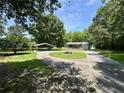 Sprawling front yard with circular driveway and carport enhances this lovely home's exterior at 485 Angham Rd, Hiram, GA 30141