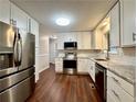 Updated kitchen features stainless steel appliances, white cabinets, and granite countertops at 485 Angham Rd, Hiram, GA 30141