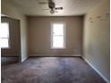 Bright living room with a ceiling fan and natural light streaming through the windows at 1094 Reynolds Ct, Morrow, GA 30260