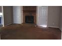 Spacious living room featuring a stone fireplace, doors, and neutral tones at 1094 Reynolds Ct, Morrow, GA 30260