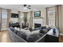 Cozy living room with fireplace, large windows and comfortable seating arrangement at 1221 Fountain Head Ct, Lawrenceville, GA 30043