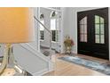 Welcoming foyer with modern light fixture, grand double door, and elegant decor at 1820 Hunters Moon Dr, Alpharetta, GA 30005