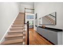 Inviting foyer with staircase, hardwood floors, and stylish decor at 35 Kenmare Hall Ne, Atlanta, GA 30324