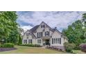 Charming two-story home with a manicured lawn, complemented by vibrant landscaping and classic architectural details at 4809 Highland Point Dr, Auburn, GA 30011