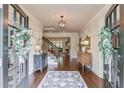 Elegant foyer with hardwood floors, decorative accents, and a staircase leading to the upper level at 4809 Highland Point Dr, Auburn, GA 30011