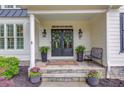 Inviting front porch featuring stone steps, elegant planters, and a welcoming entrance with stylish lanterns at 4809 Highland Point Dr, Auburn, GA 30011