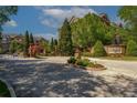Community entrance with brick sign and black metal fence surrounding the Sterling of Dunwoody at 2300 Peachford Rd # 3411, Dunwoody, GA 30338