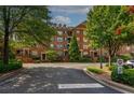 Attractive brick building surrounded by lush trees and manicured lawns, enhancing curb appeal at 2300 Peachford Rd # 3411, Dunwoody, GA 30338