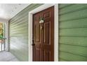 Exterior door with green siding and white trim, showing the unit number and hardware at 328 Bentley Pl # 328, Tucker, GA 30084