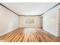 A spacious living room with hardwood floors, neutral paint, and a large window for natural light at 328 Bentley Pl # 328, Tucker, GA 30084