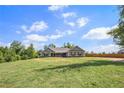 Scenic view of a single-story home with a spacious front yard, perfect for outdoor activities and Gathering gatherings at 569 Lovell Rd, Temple, GA 30179