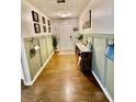 Inviting entryway with olive-toned wainscotting, hardwood floors, and stylish decor at 7113 Silver Mine Xing, Austell, GA 30168
