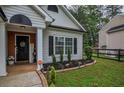A welcoming entrance with brick accents, decorative porch decor, and a well-kept lawn at 7113 Silver Mine Xing, Austell, GA 30168