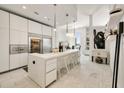 Modern kitchen with stainless steel appliances, a large island, and ample cabinet space at 285 Centennial Olympic Park Nw Dr # Ph2-7, Atlanta, GA 30313