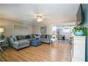 Inviting living room with hardwood floors, plush seating, and seamless flow to kitchen at 315 Charlotte Blvd, Stockbridge, GA 30281