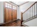 Inviting foyer featuring gleaming hardwood floors and a staircase with dark wood railing at 1435 Druid Manor, Atlanta, GA 30329