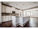 Bright kitchen featuring white cabinets, stainless steel appliances, and a large central island at 1435 Druid Manor, Atlanta, GA 30329