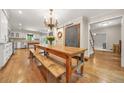 Spacious dining room with a large wooden table, hardwood floors, and chandelier at 3870 Windhurst Dr, Lilburn, GA 30047