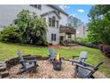 Cozy backyard fire pit area with Adirondack chairs, perfect for relaxing evenings at 3924 Lorien Nw Way, Kennesaw, GA 30152