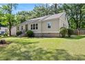 Charming home with lush lawn and landscaped yard offering superb curb appeal and inviting entrance at 1301 Eastridge Sw Rd, Atlanta, GA 30311