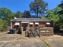 Exterior of a home with a wooden deck, minimal landscaping, and trashcans at 25 Candler Se Rd, Atlanta, GA 30317