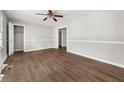 Bright bedroom with wood-look floors, fresh gray paint, and closet for ample storage at 2923 Akron St, East Point, GA 30344