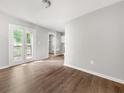Living room with gray walls, wood-look floors, and natural light from a back patio door at 2923 Akron St, East Point, GA 30344
