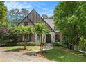 Brick Tudor-style home with manicured lawn and stone path leading to an arched entryway at 927 Berkshire Ne Rd, Atlanta, GA 30324