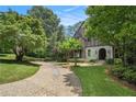 Charming Tudor-style home featuring brick and stone exterior, landscaped yard and a stone pathway at 927 Berkshire Ne Rd, Atlanta, GA 30324