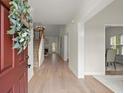 Bright entryway with hardwood floors, chandelier, staircase, and dining room at 1010 Graystone Xing, Alpharetta, GA 30005