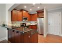 Well-appointed kitchen boasting granite countertops, stainless steel appliances, and rich wood cabinetry at 2277 Peachtree Ne Rd # 611, Atlanta, GA 30309