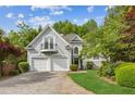 Charming two-story home with a balcony, two-car garage, and landscaped front yard at 4217 Wieuca Overlook Ne, Atlanta, GA 30342