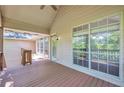 Inviting back porch with large windows offering scenic views and a cozy outdoor space for relaxation at 616 Lone Oak Ct, Lithonia, GA 30058