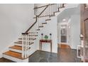 Bright foyer with hardwood stairs, tiled floors, and classic white trim at 2592 River Oak Dr, Decatur, GA 30033