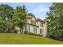 Charming two-story home featuring a well-manicured front yard and a classic design with beautiful landscaping at 600 Oakmont Hl, Duluth, GA 30097