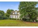 Charming two-story home featuring a well-manicured front yard and a classic design with beautiful landscaping at 600 Oakmont Hl, Duluth, GA 30097