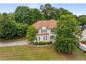 Charming two-story home featuring a well-manicured front yard and a classic design with beautiful landscaping at 600 Oakmont Hl, Duluth, GA 30097