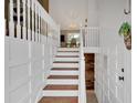 Interior view of a staircase featuring white wood and paneled walls and wood stairs at 4053 Five Oaks Ct, Powder Springs, GA 30127
