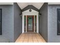 Inviting front entrance with a wood door, side lights, and decorative tile, enhancing curb appeal at 703 Kirkwood Cir, Woodstock, GA 30189