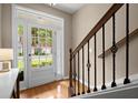 Bright entryway features hardwood floors, decorative staircase, and natural light at 2303 Waters Edge Trl, Roswell, GA 30075