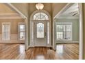 Elegant foyer with hardwood floors and a decorative glass front door, creating a welcoming entrance at 3426 Olivia Grace Way, Dacula, GA 30019