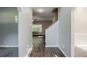 Bright hallway with wood floors leading to a living area with a ceiling fan at 6285 Polar Fox Ct, Riverdale, GA 30296