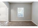 Neutral living room with plush carpeting and a window at 6285 Polar Fox Ct, Riverdale, GA 30296