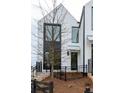 Modern home with a unique facade, complemented by minimalist landscaping and a sleek fence at 101 Pearl St, Woodstock, GA 30188