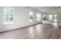 Bright, airy living room featuring hardwood floors and large windows for natural light at 101 Pearl St, Woodstock, GA 30188